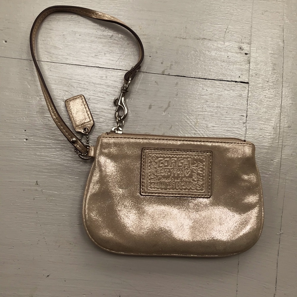 Coach small wristlet, gold lame’ with zip and one inside pocket.